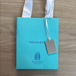 Tiffany & Co. Blue Gift Bag with Silver Landmark Charm